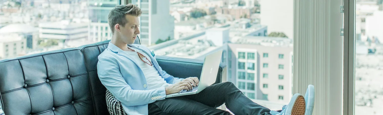 Man sitting on the longue with a laptop