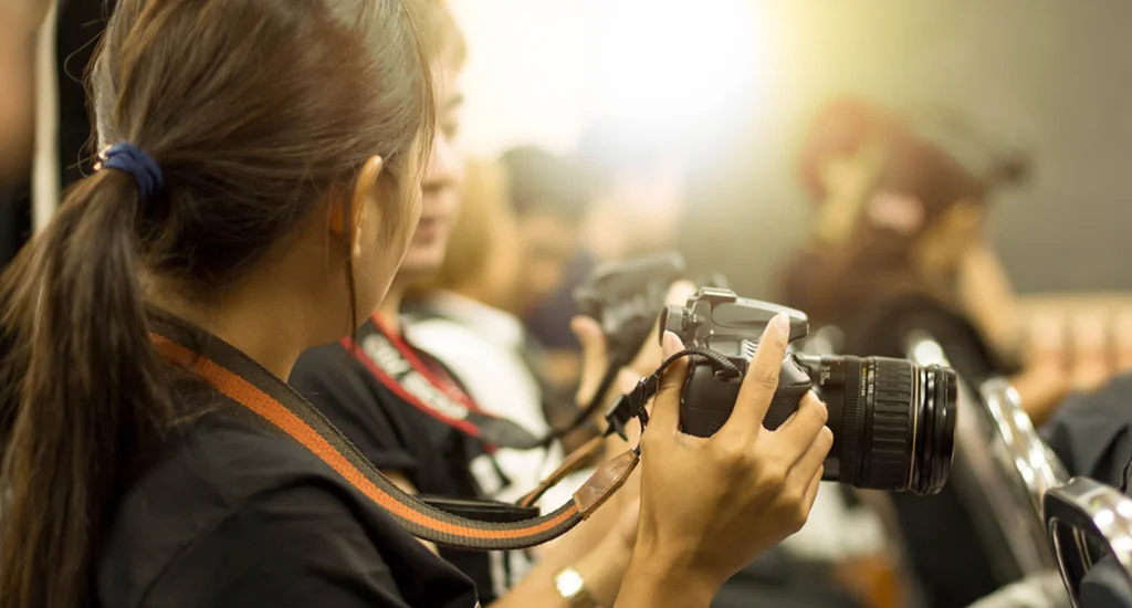 Female student taking pictures of a school event